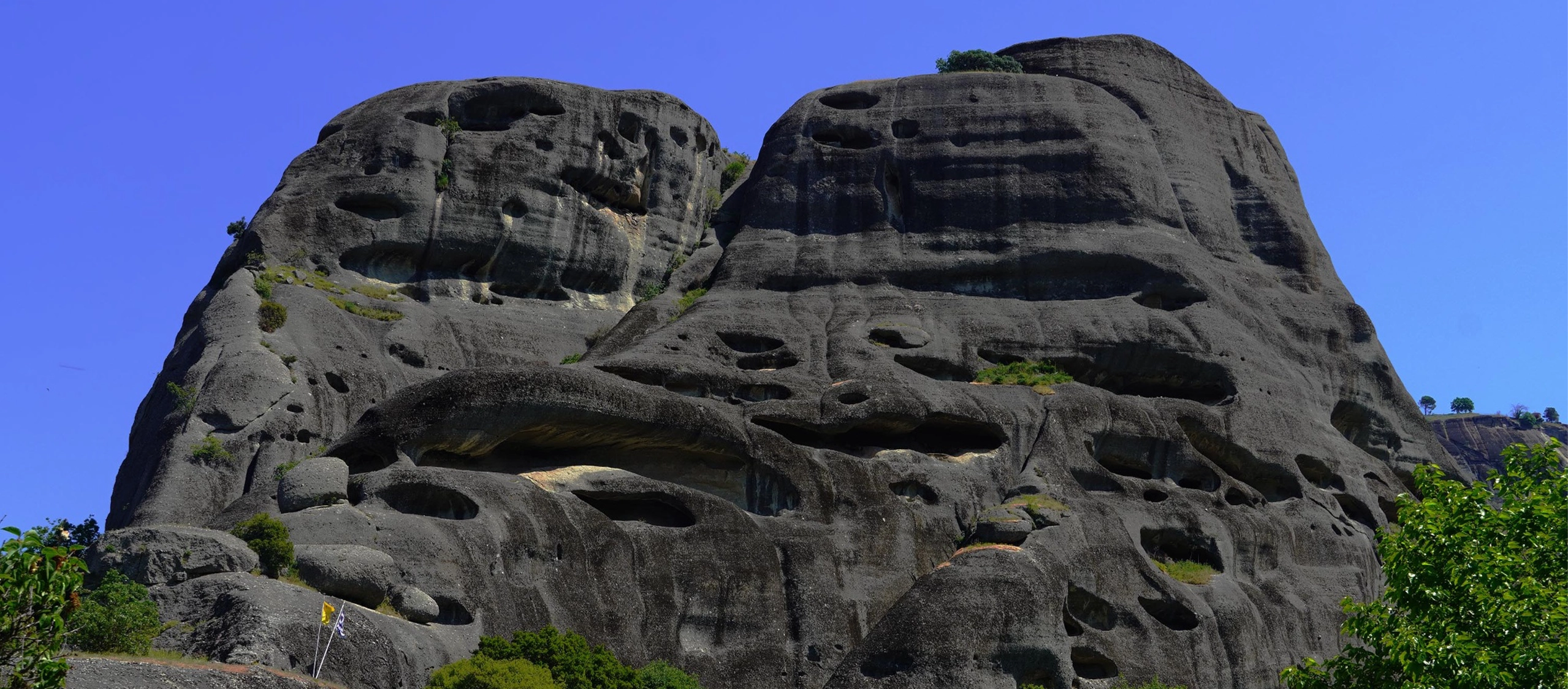 VIEW OF SKETE OF DOUPIANI HIDDEN IN METEORA GREENERY